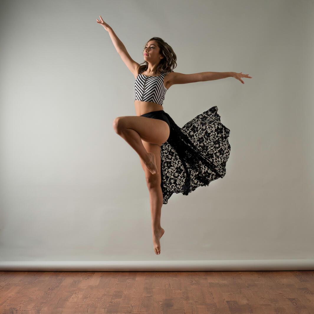 Young female dancer leaping into the air