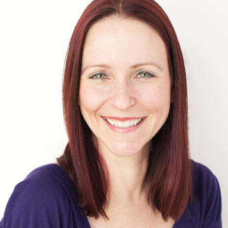 Smiling headshot of woman with red hair