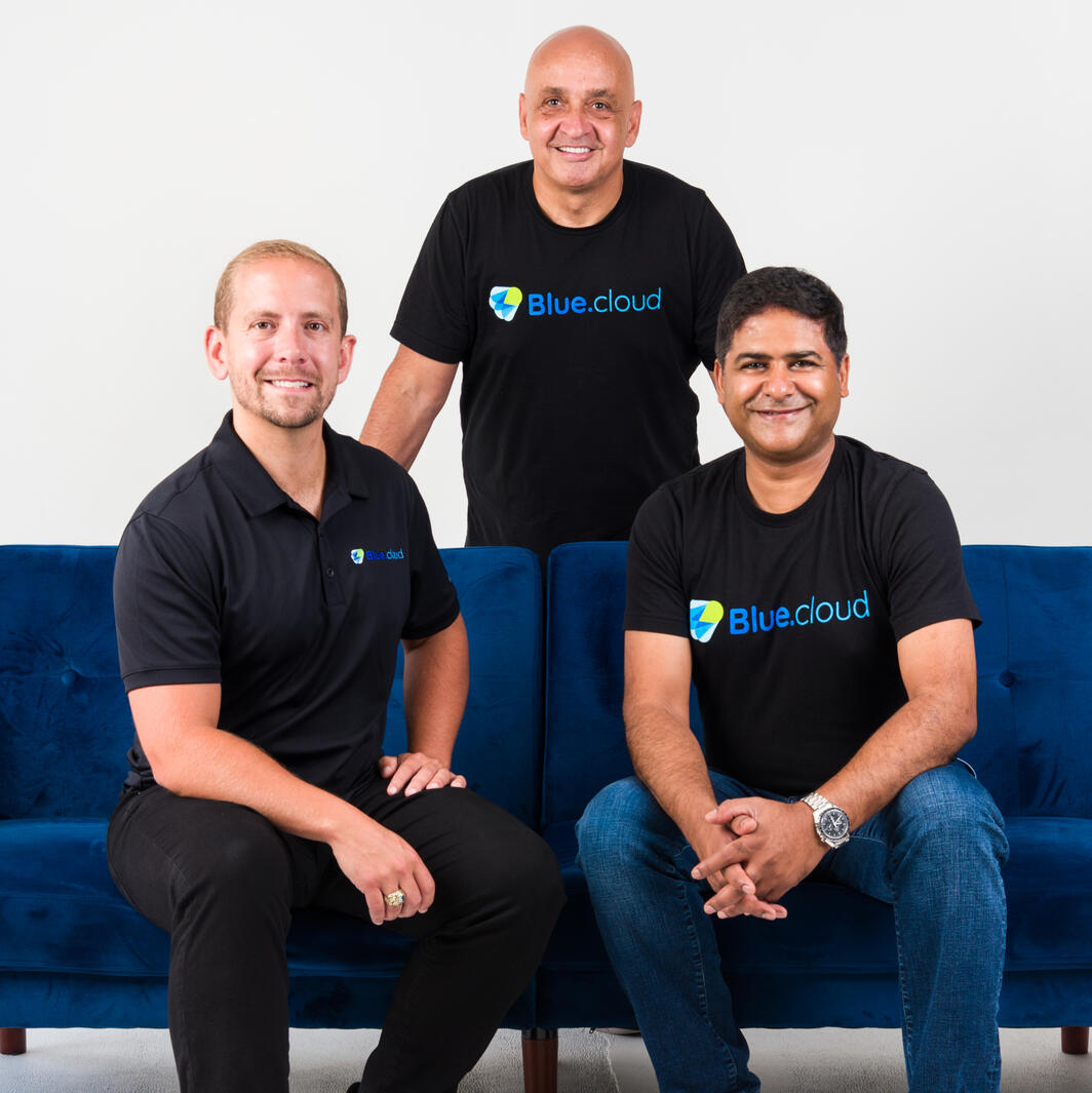 Group portrait of three executives from Blue.cloud on a blue velvet couch