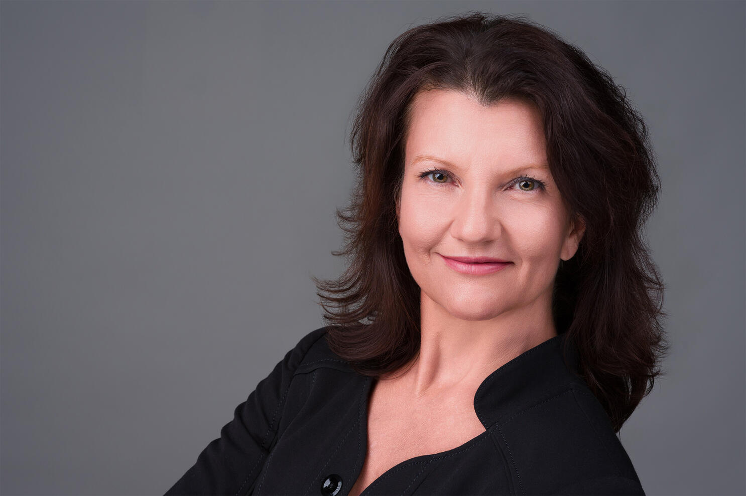 Professional business headshot of older female executive in black blouse by Tampa photographer Sidney Oster