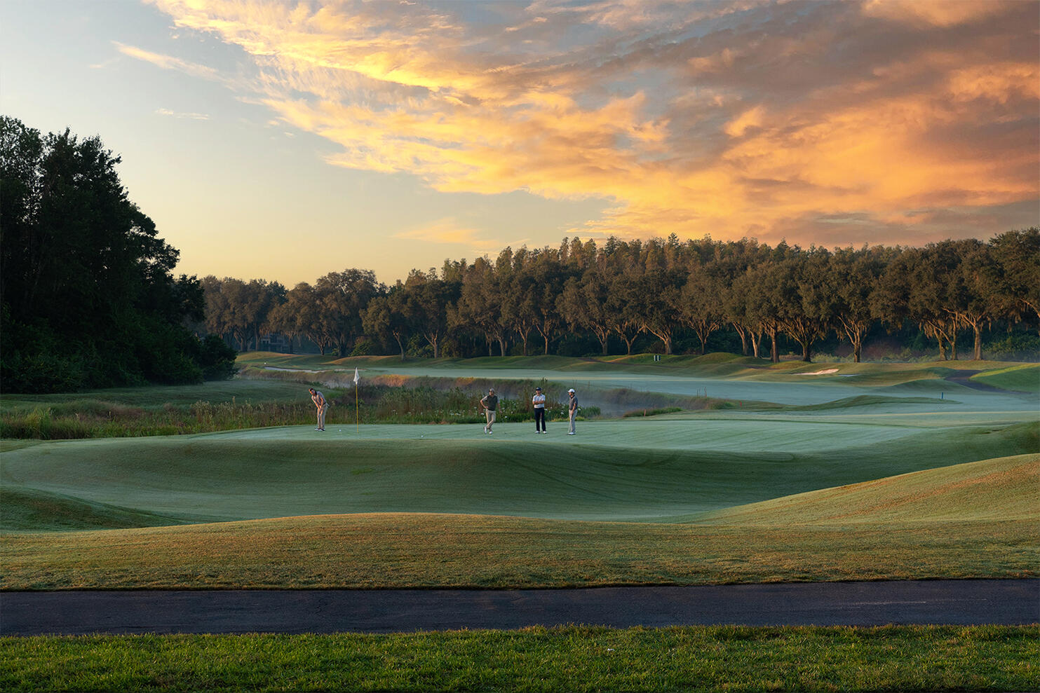 Commercial photography TPC Golf Club 18th hole golfers putting sunset Tampa photographer Sidney Oster