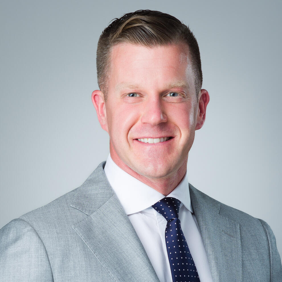 Professional business headshot of male executive in gray suit by Tampa photographer Sidney Oster