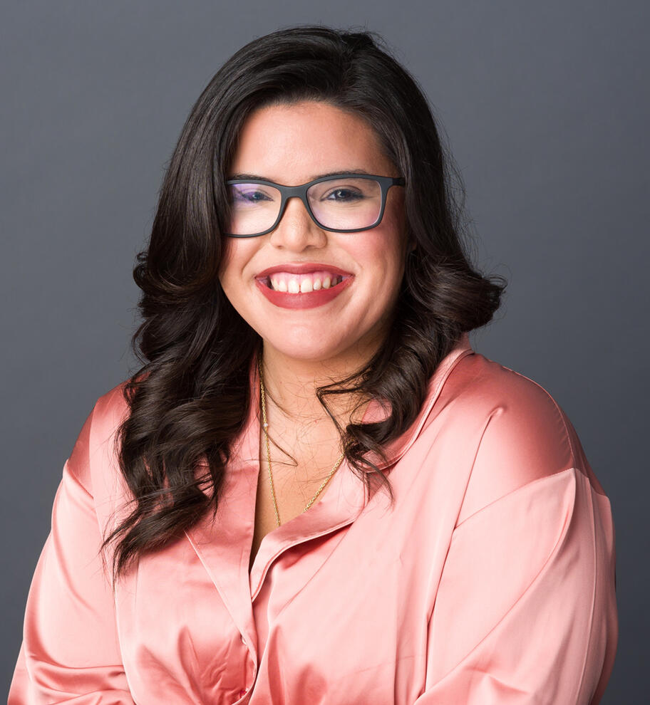 Approachable professional headshot of young woman with glasses Tampa photographer Sidney Oster