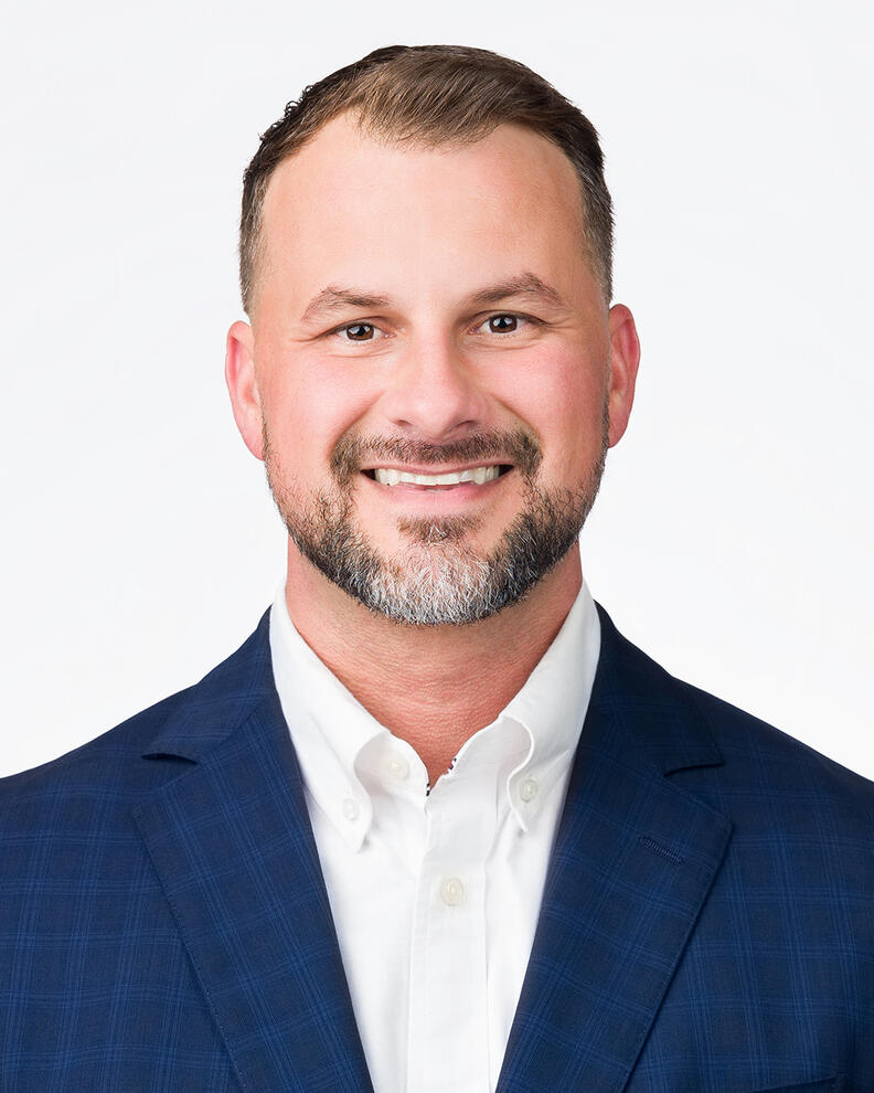 Headshot portrait for male professional smiling in blue blazer by Tampa photographer Sidney Oster