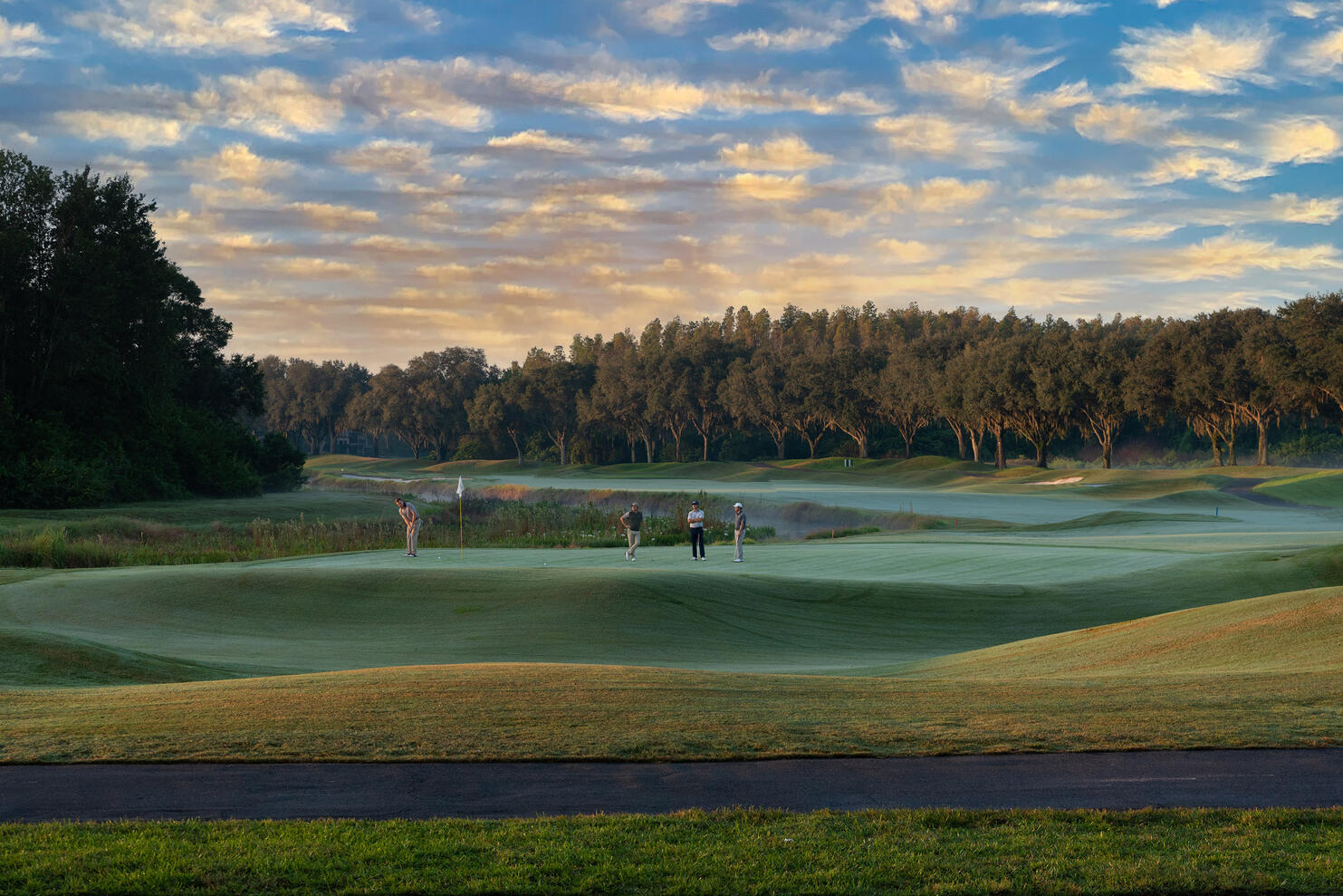Business Marketing Commercial photography TPC Golf Club 18th hole golfers putting sunset Tampa photographer Sidney Oster