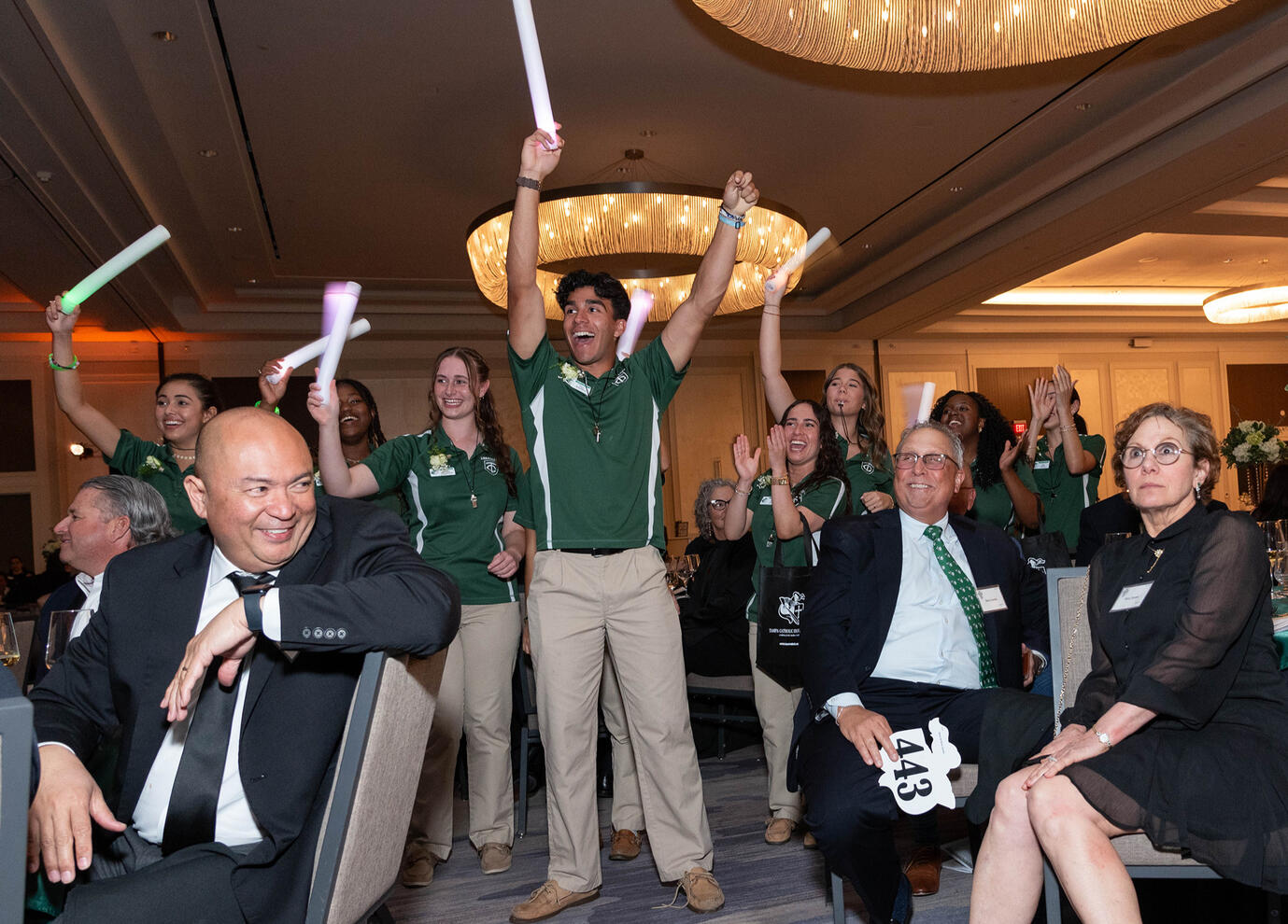People cheering after winning charity auction item