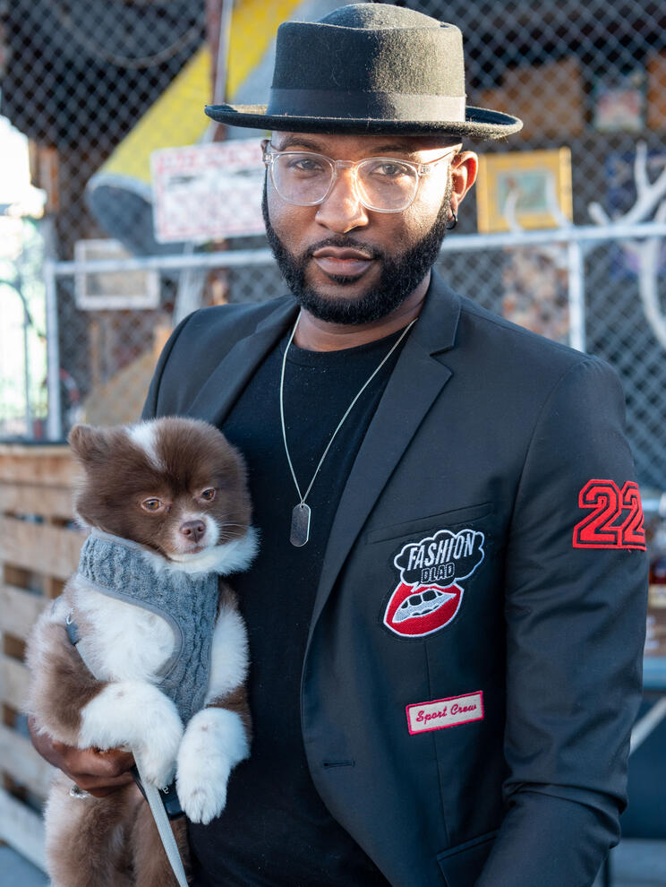 Black man holding cute tiny dog