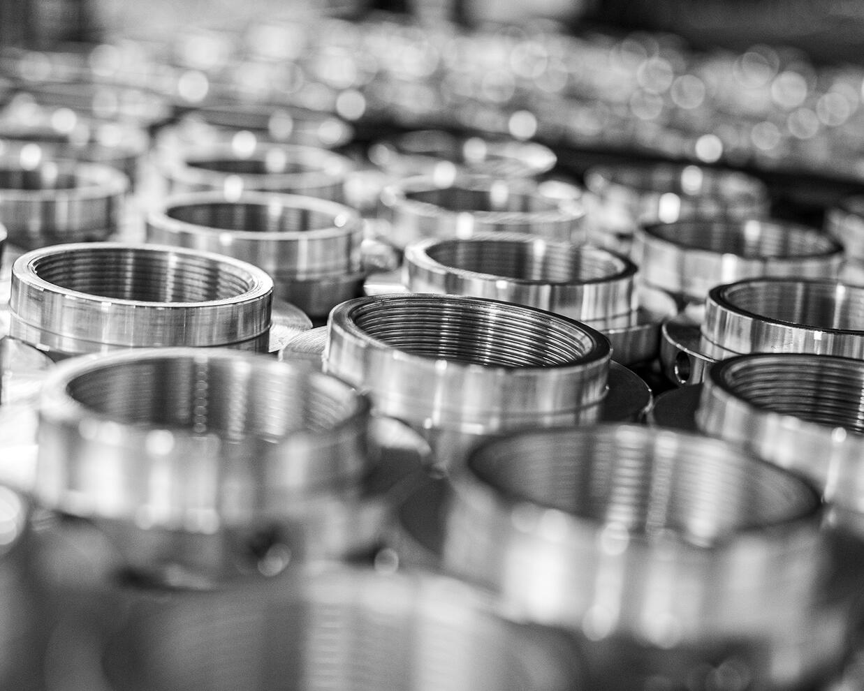 Black and white image of metal threaded parts with a narrow depth of field