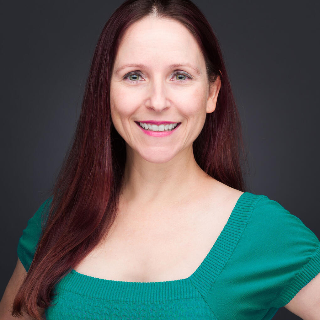 Professional business headshot of woman in green dress by Tampa photographer Sidney Oster Photography