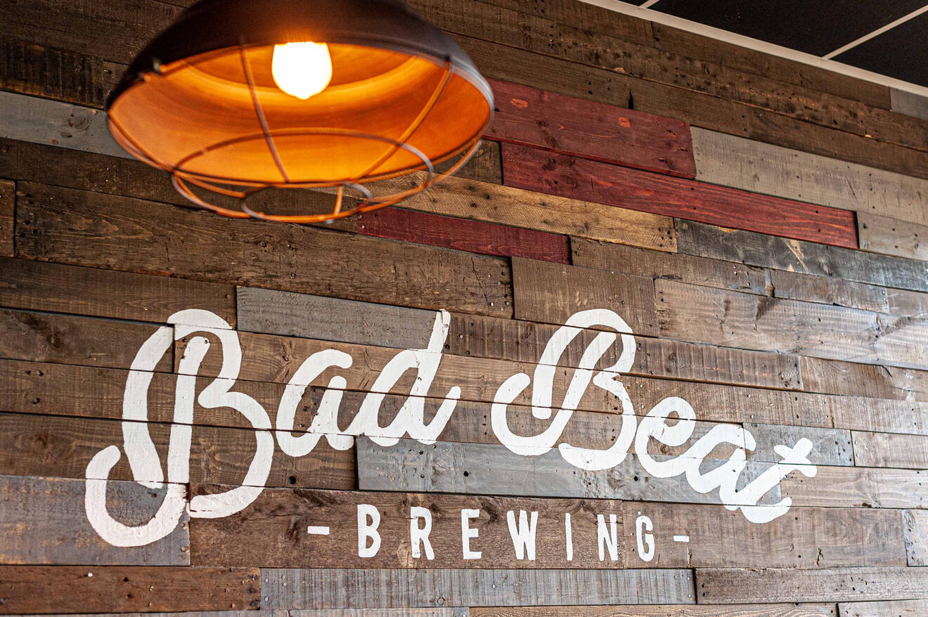 Bad Beat Brewing interior commercial photography branded wood wall and industrial lighting by Tampa Sidney Oster Photography