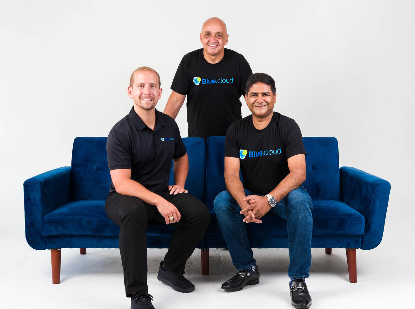 BlueCloud team portrait on couch Professional Tampa executive team photography for BlueCloud showing three business leaders in corporate portrait session by Sidney Oster Photography